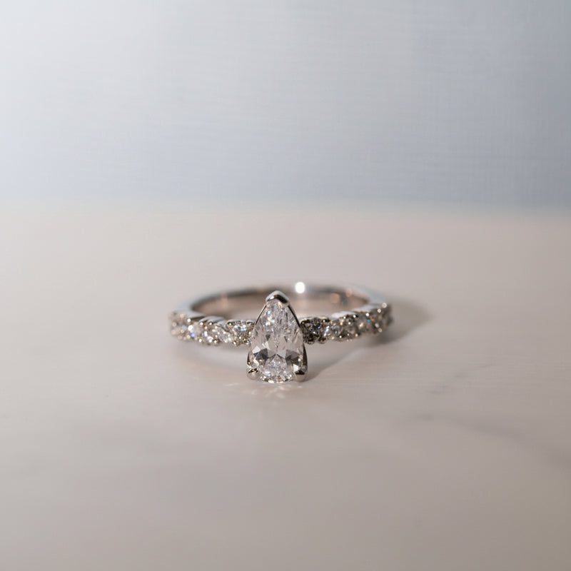The Adelynn Ring flatlay by Ethica Diamonds with pear cut lab grown centre diamond