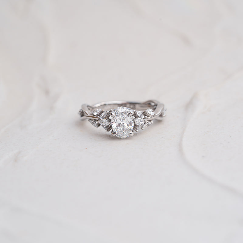Flat lay of The Eesha nature inspired twisted vine engagement ring with marquise accents and split twisted shank