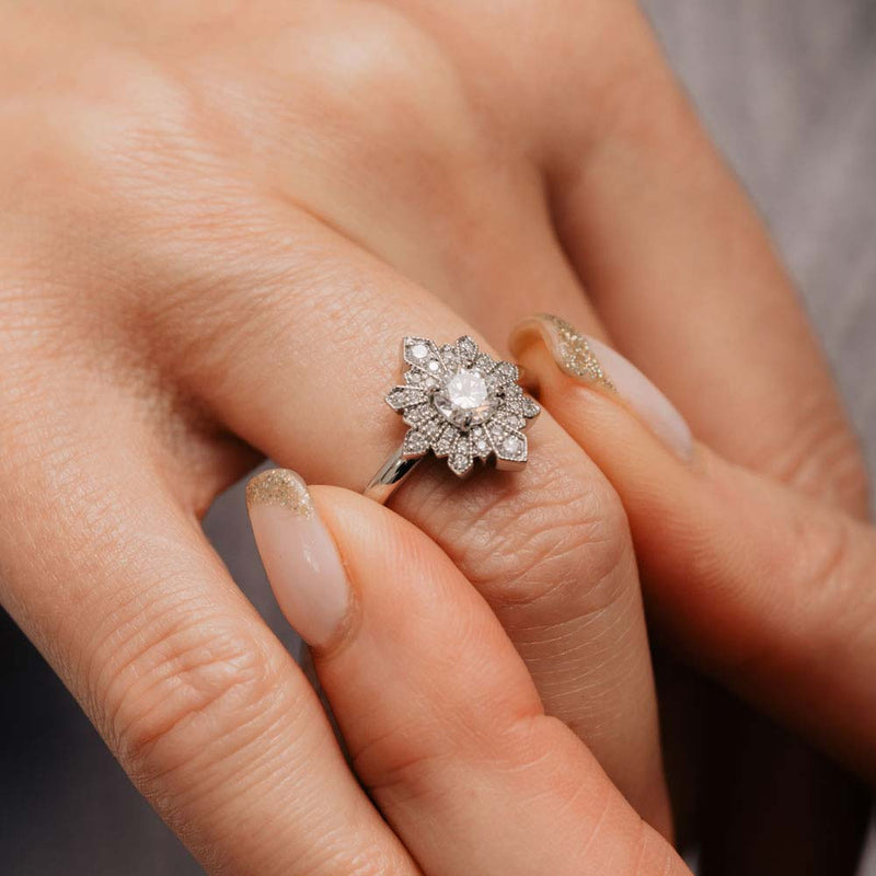 Edwardian-inspired halo engagement ring with sunburst design