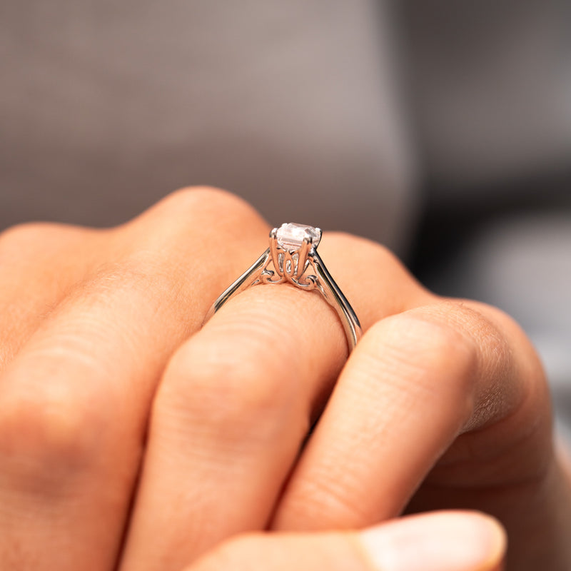 The Franchesca antique style emerald cut engagement ring with vimtage inspired floral scrolling and open daylight shoulders