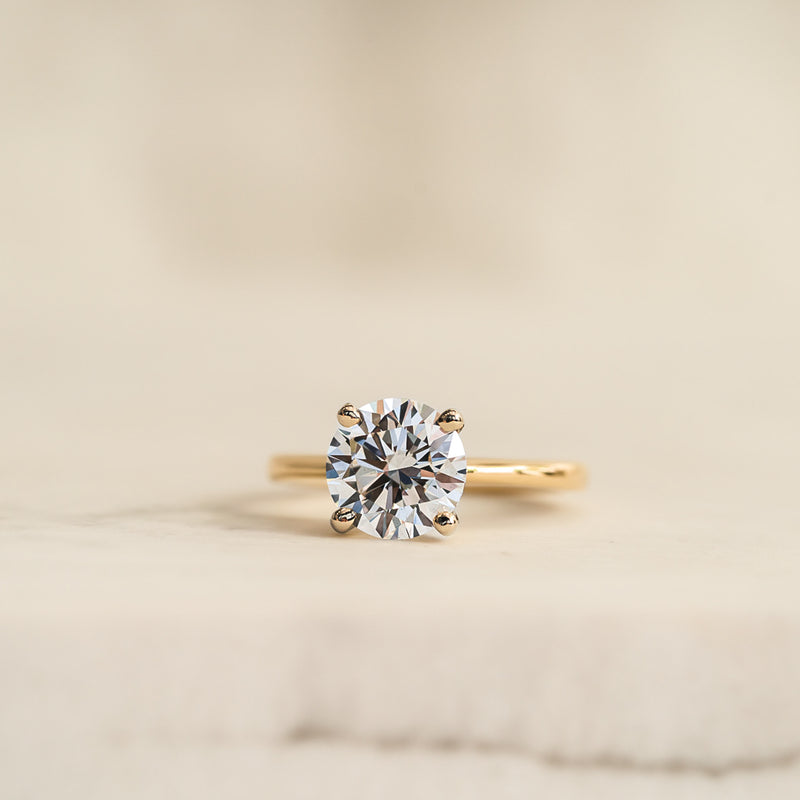 The frankie by ethica diamonds is a thin band solitaire engagement ring with a round lab grown diamond