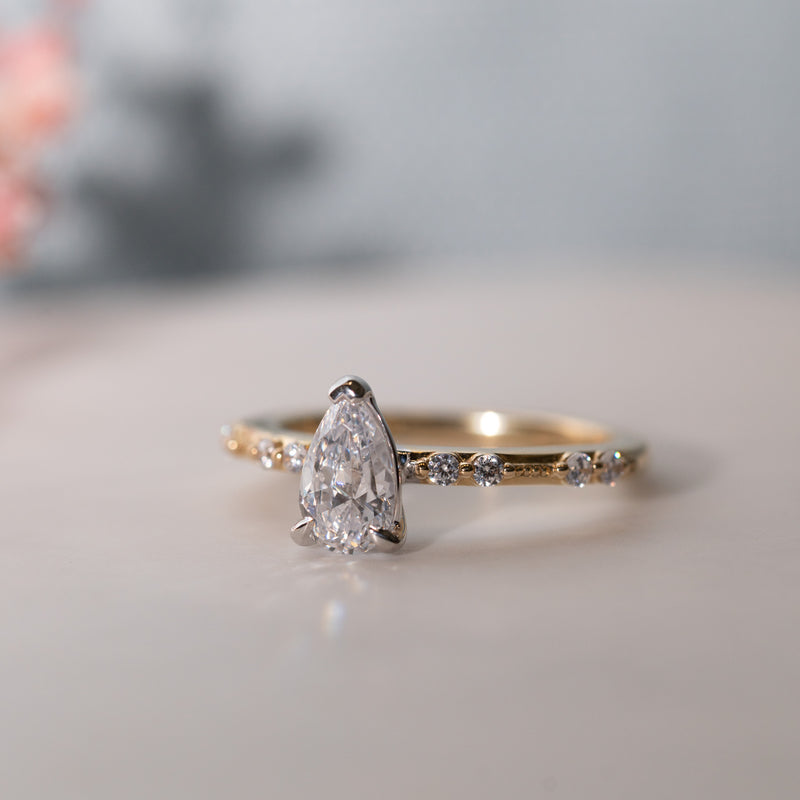 Close-up of The Hope Ring pear cut centre and shoulder-set diamonds