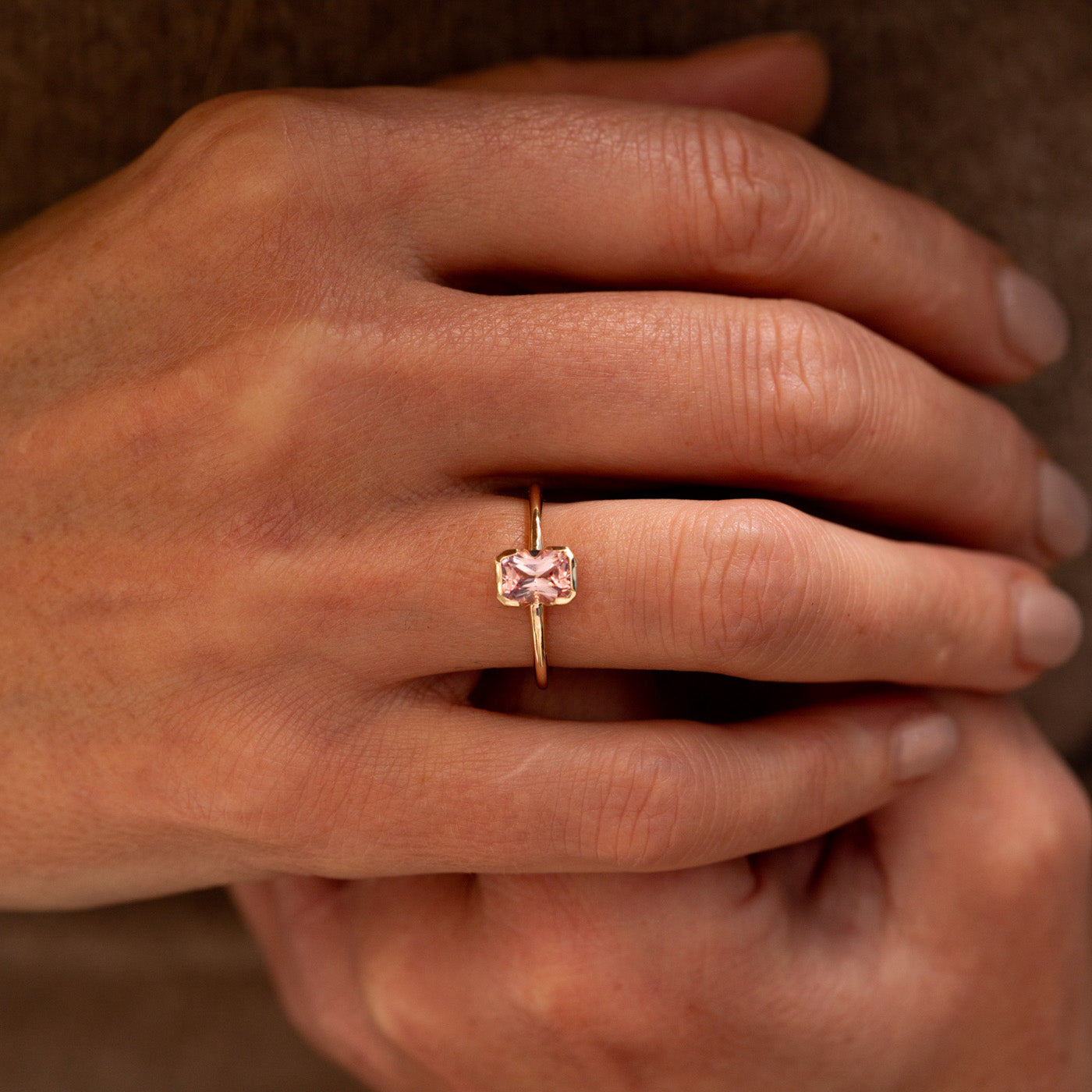 The Danae Ring - peachy pink Chatham® champagne sapphire cushion cut engagement ring, rubover setting, recycled yellow gold, Ethica Diamonds Cornwall