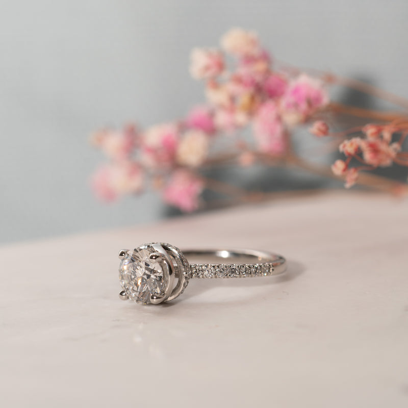 1.5ct Aaro single stone engagement ring laid flat showing diamond set shoulder band
