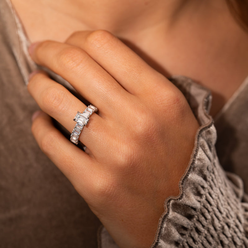 A lab diamond emerald cut ring with baguette diamonds on band. 