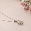 2.0ct classic oval diamond pendant in platinum flat lay on table side view