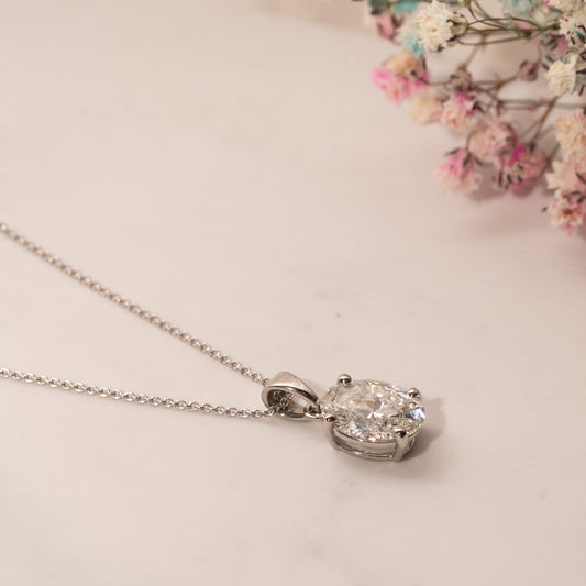 2.0ct classic oval diamond pendant in platinum flat lay on table side view