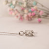 2.0ct classic oval diamond pendant in platinum flat lay on table side view