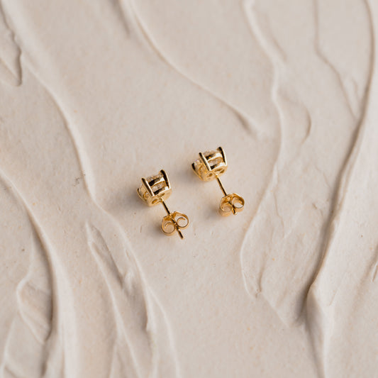 side view of The Camille Earrings minimalist diamond studs in yellow gold