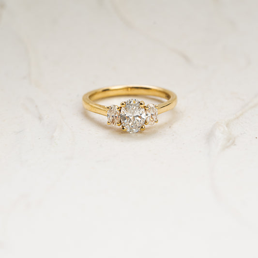 Cinta Ring by Ethica Diamonds is a lab created oval diamond engagement ring with graduated oval side stones in trilogy design