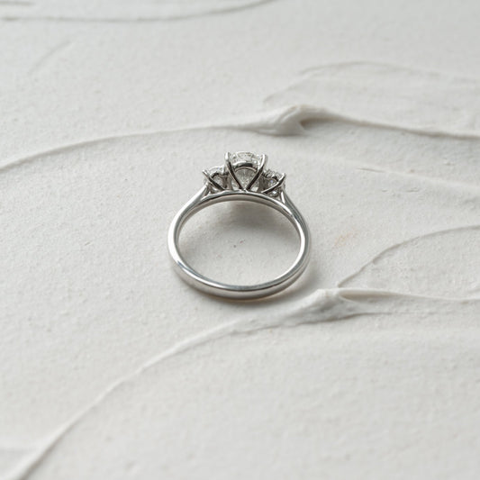 Delicate 18k gold 3 stone lab created oval engagement ring viewed from back