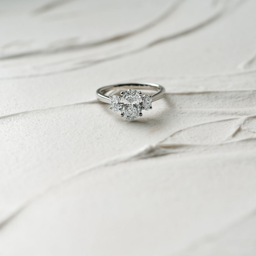 Cinta Ring by Ethica Diamonds is a lab created oval diamond engagement ring with graduated oval side stones in trilogy design