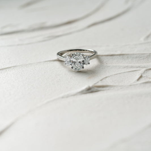 Cinta Ring by Ethica Diamonds is a lab created oval diamond engagement ring with graduated oval side stones in trilogy design