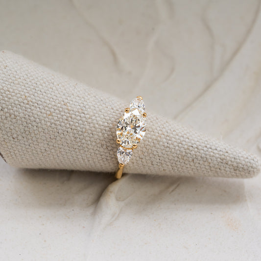 18 karat recycled gold engagement ring photographed on light fabric ring stand
