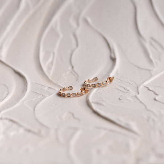 Curved silhouette gold hoops with polished diamond detail. By Ethica Diamonds