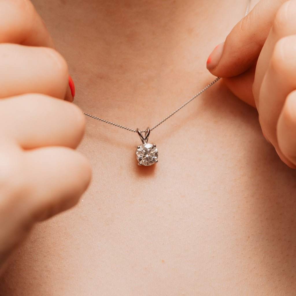 split bail diamond pendant in platinum on neck