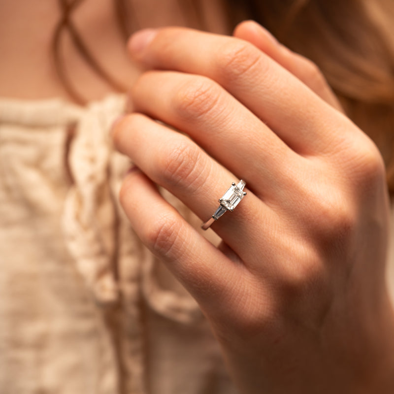 Art Deco inspired trilogy engagement ring with tapered baguette diamonds