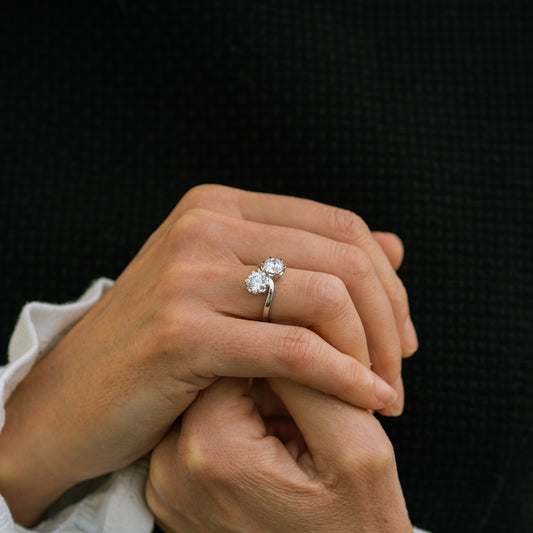 Model showing platinum diamond engagement ring with pair of centre stones 