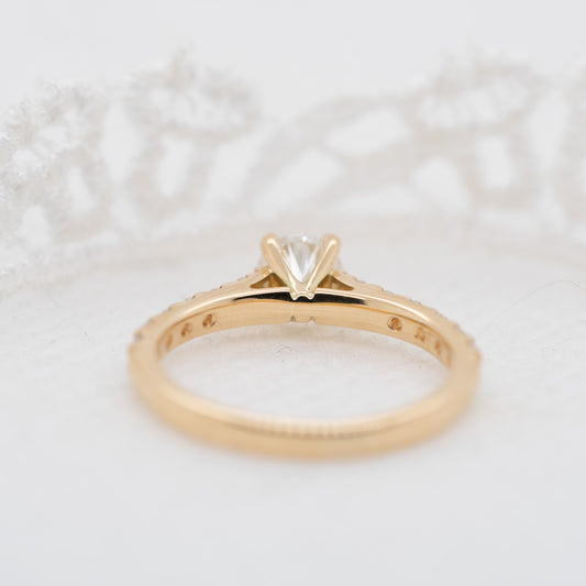 Yellow gold pave diamond shoulder set engagement ring with sweeping curved claws and open daylight shoulders