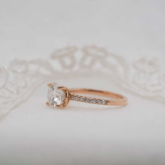 rose gold petite dainty shoulder set diamond ring with pave diamonds in band and classic solitaire setting