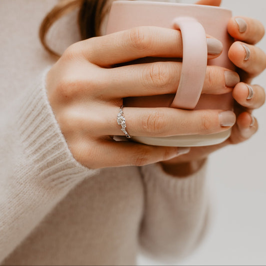 Model holding mug whilst wearing sustainable diamond engagement ring with lab created diamonds made in cornwall