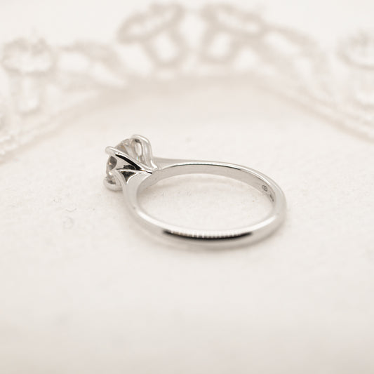 Flat lay of platinum diamond ring thin band solitaire engagement ring 