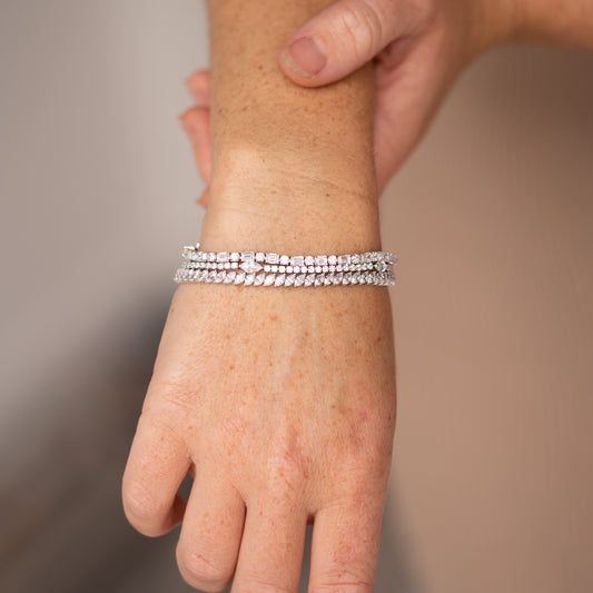 Silver bracelet on a wrist with a blurred background