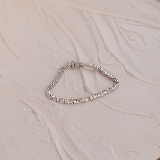 white gold tenis bracelet with lab diamonds from Cornwall on a beige fabric background