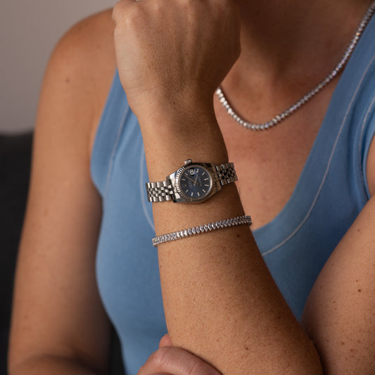 Person wearing a silver watch and Diaond Tennis bracelet in Cornwall 