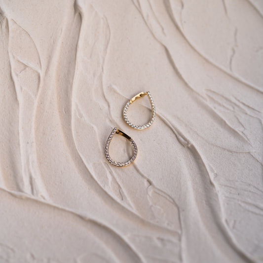Close-up of Mara pavé spiral hoops in 9k gold by Ethica Diamonds Cornwall