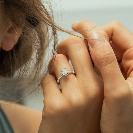 Model wears platinum rectangular modern diamond ring with very square and angular profile