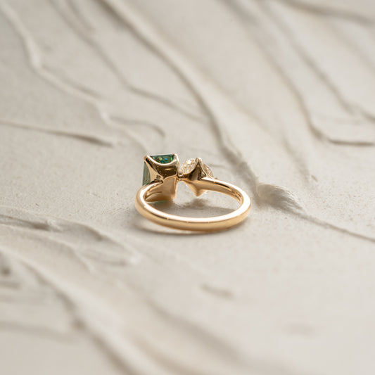 Shimmering 18k gold engagement ring with two paired centre stones. Ethical diamond luxury