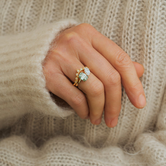 model wears tiara crown shaped wedding band with toi et moi engagement ring in recycled gold