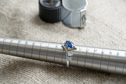 Blue sapphire art deco engagement ring with split shank on finger size pole