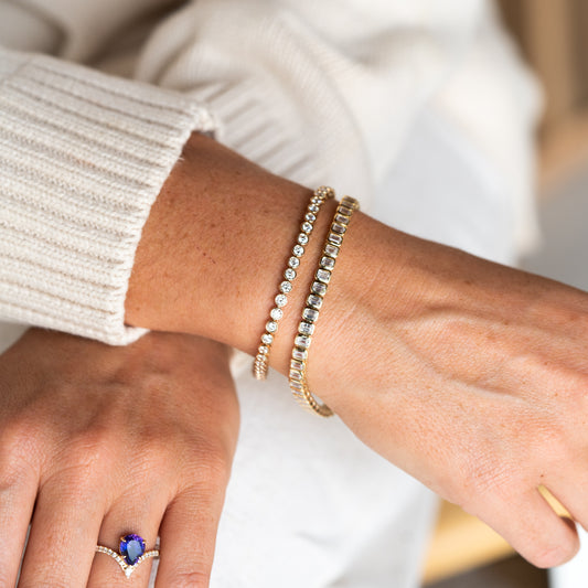 Close-up of a wrist wearing two Cornish diamond bracelets 