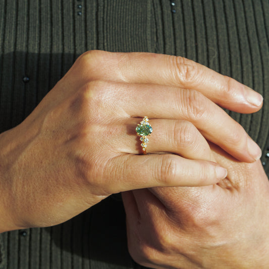 Hand wears the serephina by ethica diamonds green oval yellow gold solitaire engagement ring