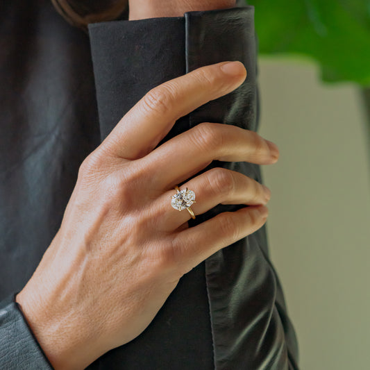 Hand wearing a ethical lab diamond ring with a blurred background