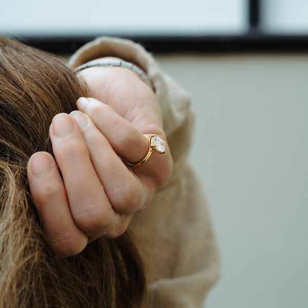 model wearing sustainable diamond jewellery from cornwall with elongated cushion hidden halo lab diamond engagement ring 