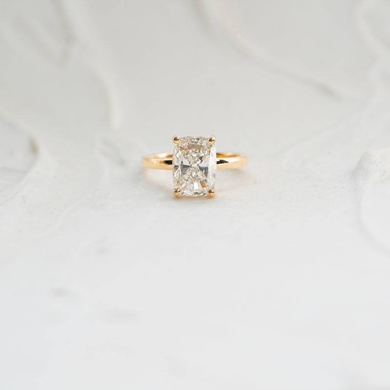 yellow gold solitaire elongated cushion hidden halo diamond engagement ring by ethica diamonds in cornwall