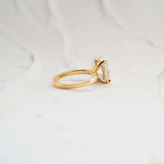 Sustainable recycled gold wedding ring with hidden diamond halo beneath cushion cut diamond
