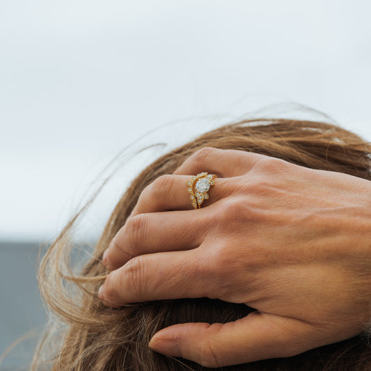 model on cornwall beach wearing engagement ring wedding set bridal in yellow gold with lab diamonds by ethica diamonds
