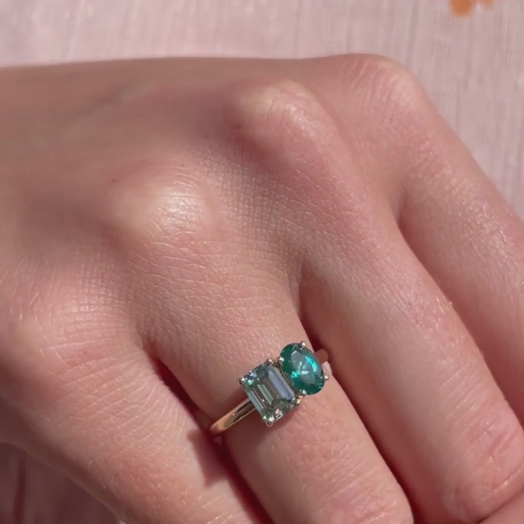 Model shows a Paraiba 0.88ct coloured spinel and emerald cut Moissanite Toi et Moi Ring by Ethica Diamonds