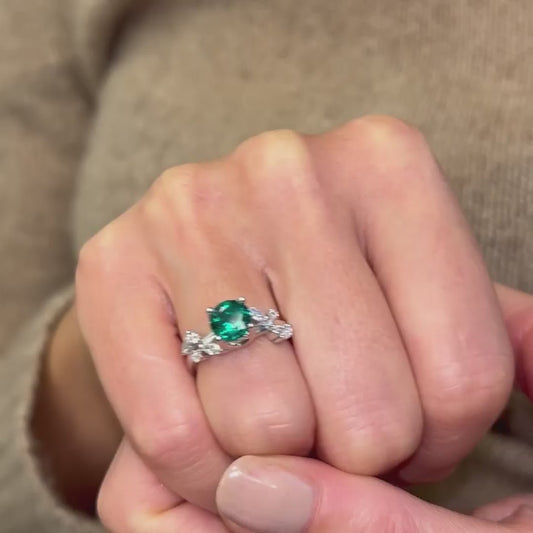 green moissanite ring with nature style leaf vine detailed engagement ring shown on hand
