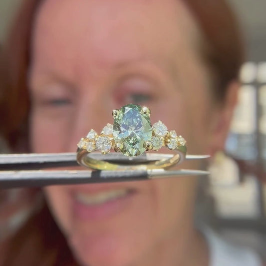 Video of yellow gold and green diamond ring with side accent stones 