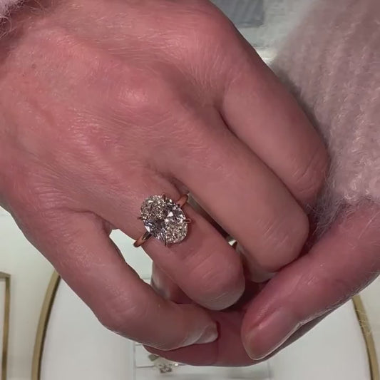 video of sparkling 4ct oval cut diamond with talon claws on models hand