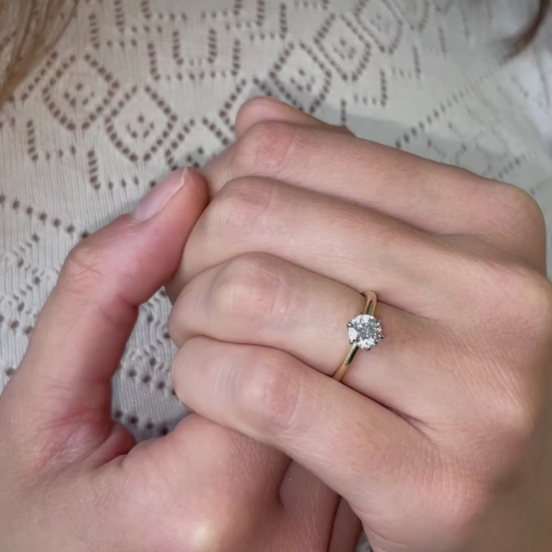 video of Cyra engagement ring on hand. solitaire round classic Tiffany design