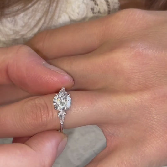 Trilogy diamond ring shown on hand of model Kite Cut