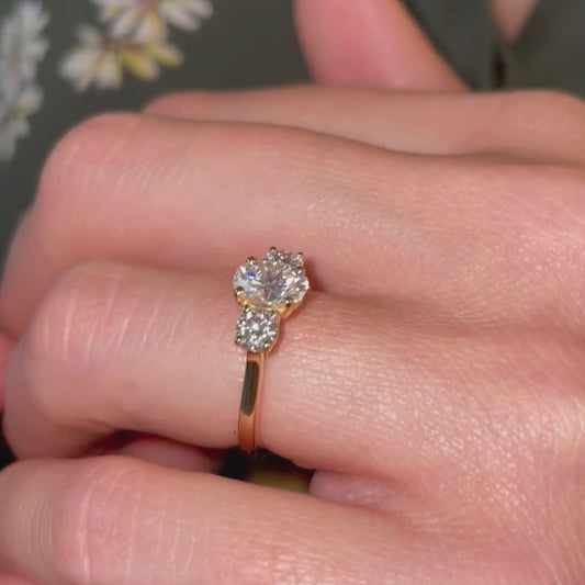 model wears trilogy classic three stone engagegement ring design with lab created diamonds in yellow gold