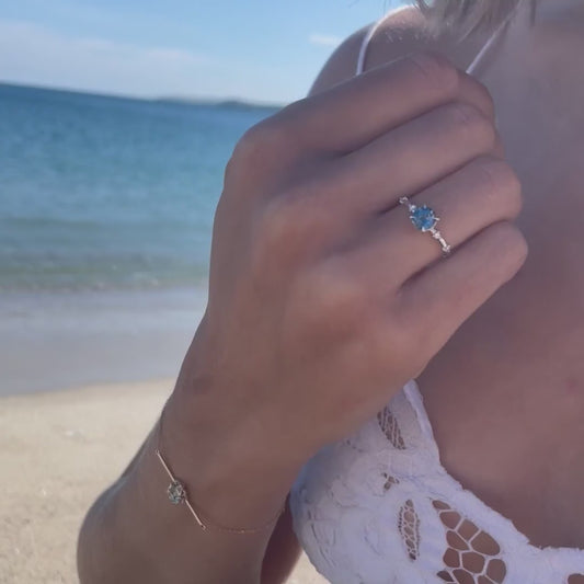 Model showing the oval-cut blue topaz  Sowena Ring set in a white gold band