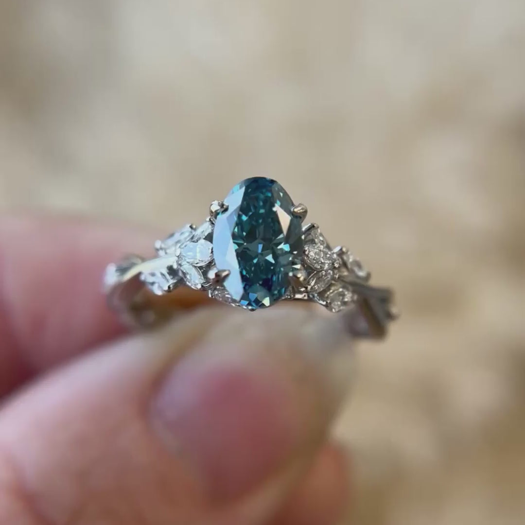 Oval blue lab diamond in petite twisted vine engagement ring design with marquise accent diamonds nature inspired setting